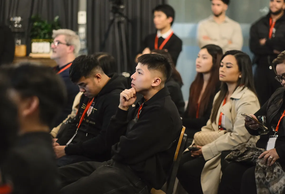 Members seated in rows, listening to a talk at a BNB Success event.